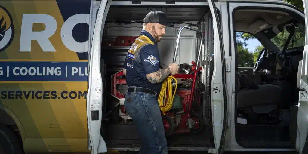 Torch uniformed technician retrieving equipment from a Torch truck.